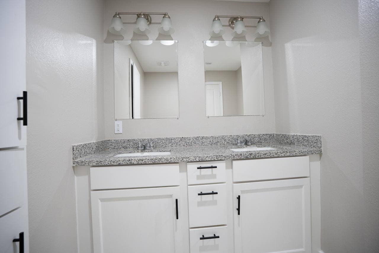 Double vanity bathroom renovation with granite countertop
