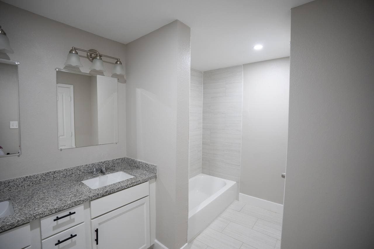 Bathroom renovation with soaking tub and tiled surround