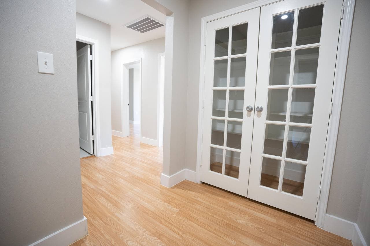 Hallway renovation with French doors and new flooring