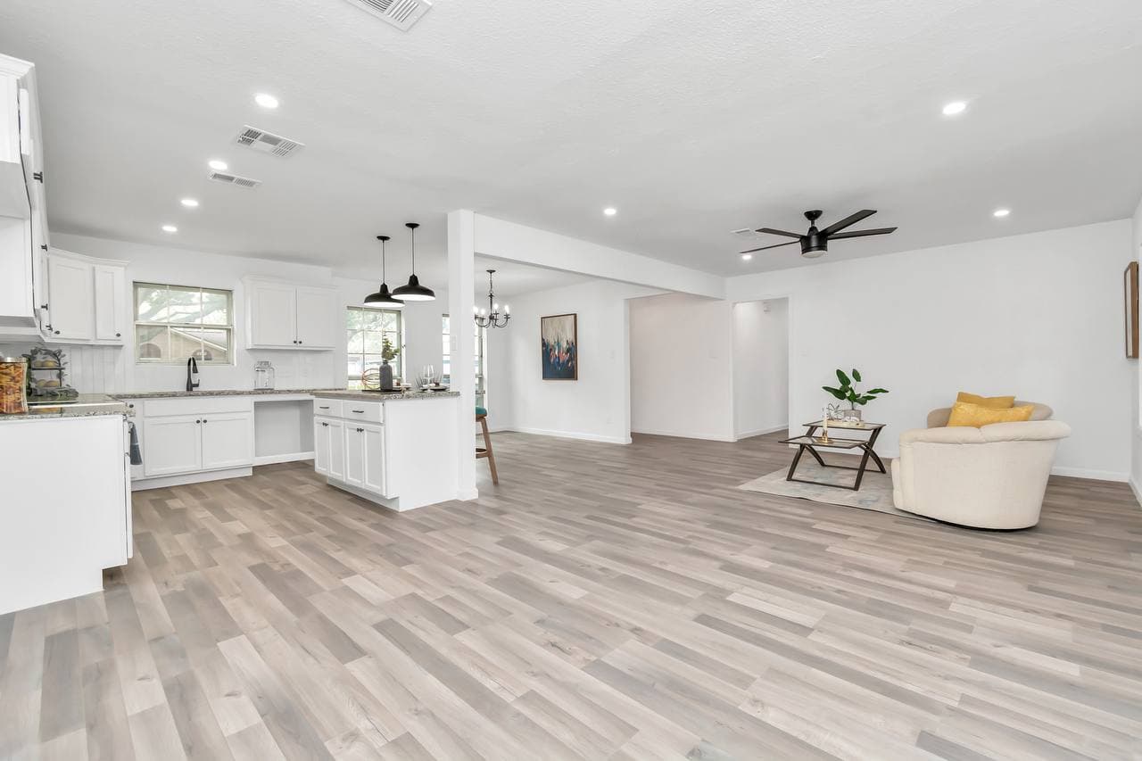 Kitchen renovation with black pendant lights and quartz countertops