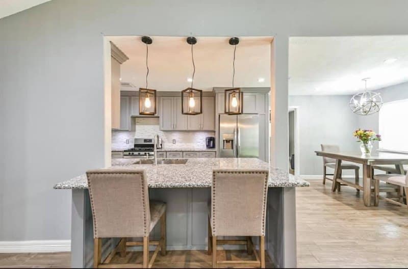 Open kitchen renovation with living room and stone fireplace