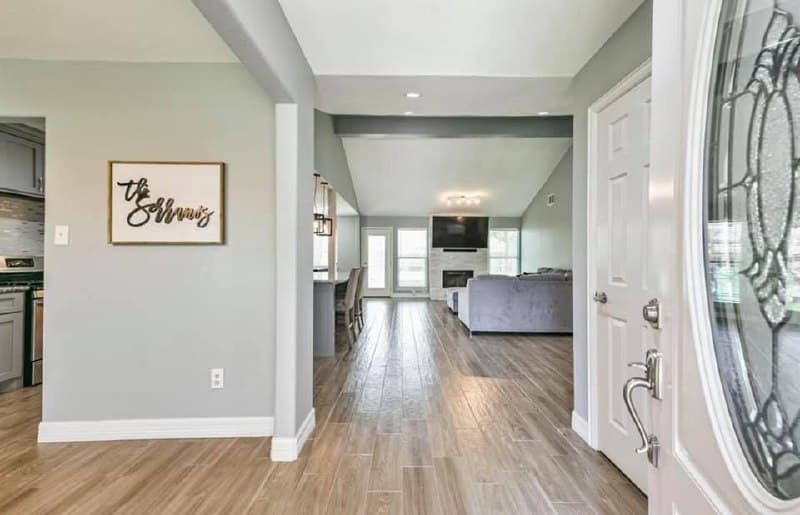 Full home renovation — entry with stained glass door and open floor plan